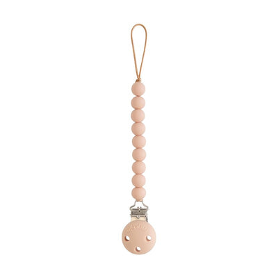 Mushie silicone pacifier clip in blush color with round beads and silver clip for securing pacifiers.