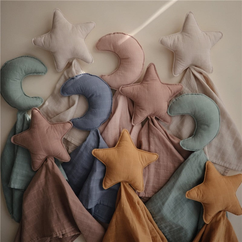 Mushie Star Lovey in fall yellow, featuring a soft star-shaped plush and various colored fabric blankets.