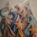 Mushie Star Lovey in fall yellow, featuring a soft star-shaped plush and various colored fabric blankets.