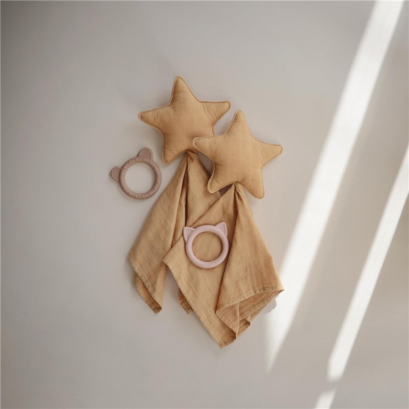 Mushie Star Lovey in fall yellow features two star-shaped plush toys and two soft, textured teething rings in muted tones.
