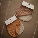 Mushie Organic Cotton Muslin Burp Cloths 2-Pack in blush and fog colors, displayed folded with hang tags.