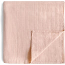 Mushie Muslin Swaddle Blanket in blush color, featuring a soft, textured fabric with a diamond pattern.