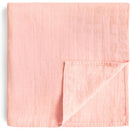Mushie Organic Cotton Muslin Swaddle Blanket in a soft rose vanilla color, featuring a textured, quilted design.