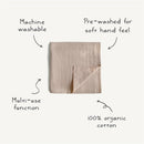 Organic cotton muslin swaddle blanket in sage color, machine washable, pre-washed for softness, versatile for multi-use.