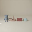 Mushie Pirate Mold Free Bath Play Set featuring a pirate figure, a sailboat, a treasure chest, and a geometric shape.