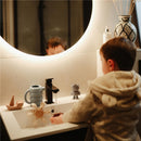 Mushie Pirate Mold Free Bath Play Set displayed by a child in a cozy bathroom, featuring colorful bath toys by a sink.