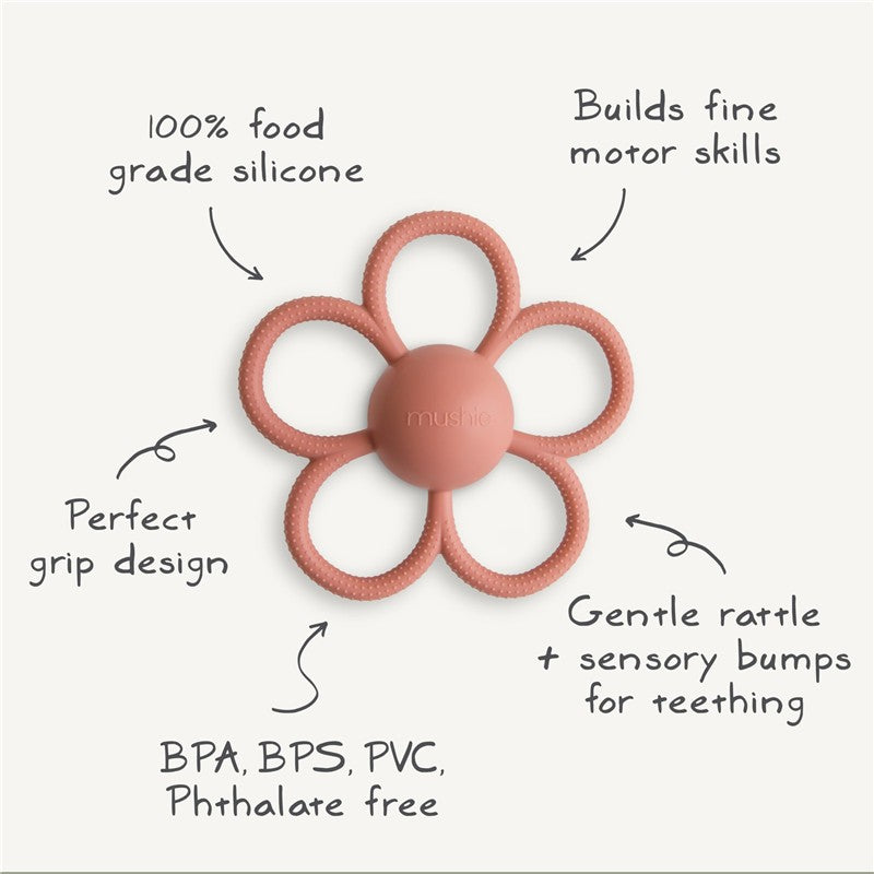 Soft lilac Mushie Daisy Rattle Teether made of 100% food-grade silicone; features sensory bumps and a gentle rattle.