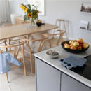 Mushie Baby Food Freezer Tray in Cambridge Blue rests on a kitchen counter next to a bowl of apples and rubber bands.