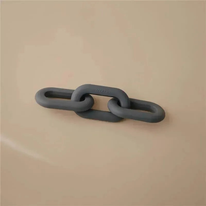 Silicone baby teether toy in a chain link design, colored grey, against a neutral background.
