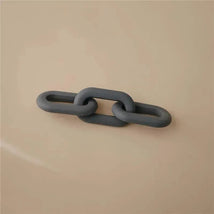 Silicone baby teether toy in a chain link design, colored grey, against a neutral background.