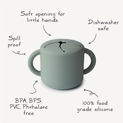 Powder blue Mushie silicone snack cup with soft opening, spill-proof design, and dishwasher safe features.