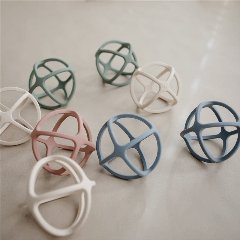 Silicone ball teethers in various pastel colors, featuring a soft, interlocking design for babies to chew on.