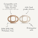 Mushie Silicone Bottle Handles 2-Pack in blush and shifting sand, compatible with most baby bottles, made of food-grade silicone.