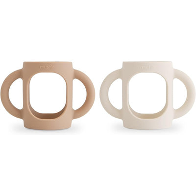 Silicone bottle handles in natural and shifting sand colors, designed for easy gripping by children.