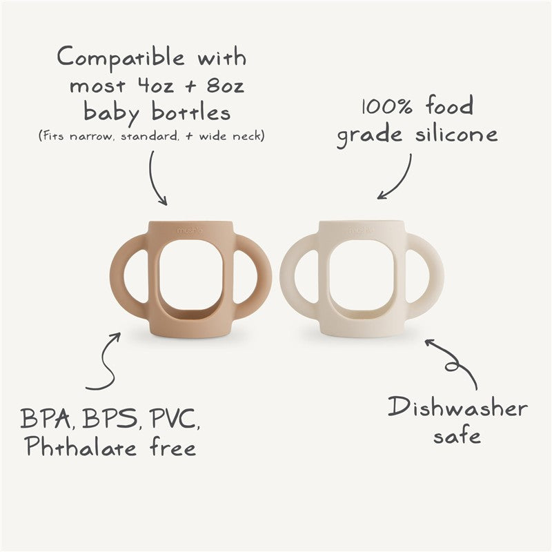 Mushie Silicone Bottle Handles in Natural and Shifting Sand colors; compatible with most baby bottles, BPA-free, dishwasher safe.