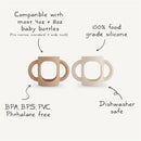 Mushie Silicone Bottle Handles in Natural and Shifting Sand colors; compatible with most baby bottles, BPA-free, dishwasher safe.