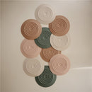 Mushie Silicone Drain Stopper 2-Pack in blush and shifting sand colors, featuring circular, ridged designs.
