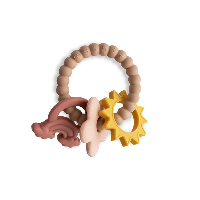 Silicone teething ring featuring a central beaded ring and three attachments: a pink flower, a red rainbow, and a yellow sun.