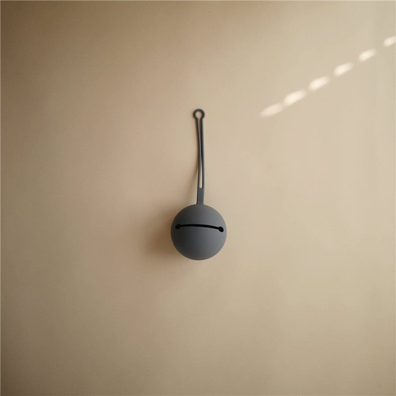 Mushie Silicone Pacifier Holder Case in Tradewinds color, featuring a minimalist design with a loop for hanging.
