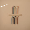 Mushie silicone replacement straws in various colors, displayed in a 5-pack, with two cleaning brushes included.
