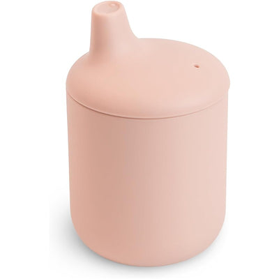 Mushie Silicone Sippy Cup in a blush color with a rounded body and a spout on top for easy drinking.