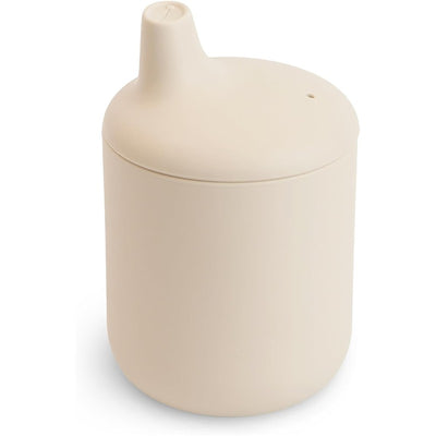 Mushie Silicone Sippy Cup in Shifting Sand color, featuring a smooth, rounded design and a spout for easy drinking.