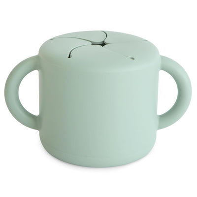 Silicone snack cup in Cambridge Blue, featuring a round shape and two handles, designed for toddlers.