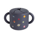 Silicone snack cup featuring a dark gray color with colorful planet designs, ideal for toddlers.