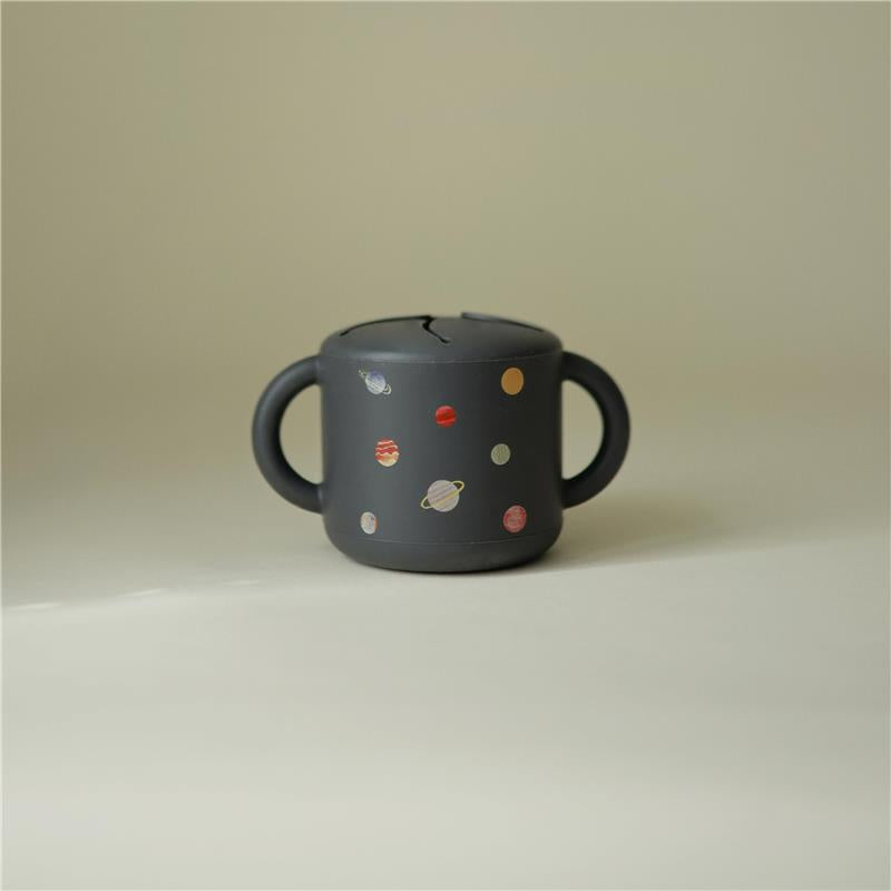 Silicone snack cup in dark grey with colorful planet designs, featuring two handles and a top opening for easy access.