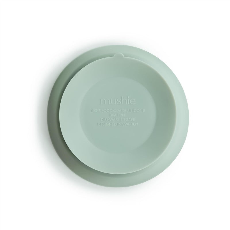 Silicone suction bowl in Cambridge blue, made from food-grade silicone, marked as dishwasher safe and designed in Sweden.