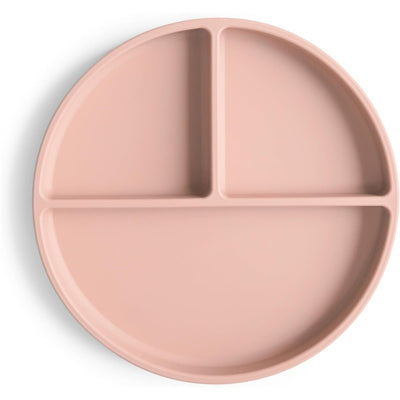 Silicone suction plate in blush color, featuring three divided sections for serving food.