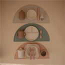 Mushie Silicone Suction Plates in ivory, featuring three plates with various utensils and cups arranged neatly.
