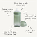 Mushie Soft Spout Sippy Cup in Tradewinds color features a soft silicone spout, measurement markings, and a removable lid.
