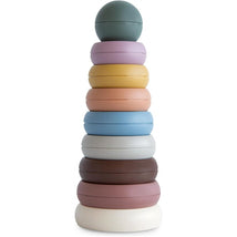Multi-colored Mushie stacking rings in a tower, featuring a round mint green top ring and various pastel base rings.