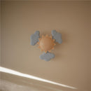 Suction spinner toy featuring a central sun surrounded by soft, gray clouds, ideal for sensory play.