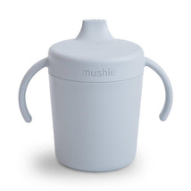 Trainer sippy cup by Mushie in a soft cloud color, featuring two handles and a spill-proof lid.