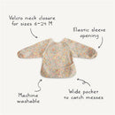 Water-resistant long sleeve baby bib in a floral pattern, featuring Velcro neck closure, elastic sleeve openings, and a wide pocket.