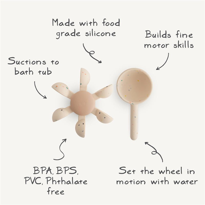 Mushie Water Wheel Bath Toy made from food-grade silicone, suctions to the tub, promotes motor skills, and is free from harmful chemicals.