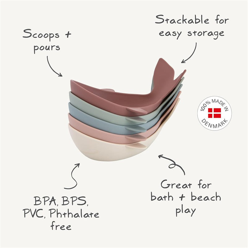 Mushie Whale Bath Stackers in pastel colors, designed for scooping and pouring; stackable for easy storage. 100% made in Denmark, BPA-free.