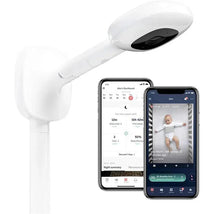 Nanit Pro Camera attached to a wall mount, with two smartphones displaying a baby monitoring app and live video.