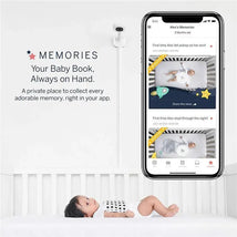Nanit Pro Camera with wall mount beside a smartphone displaying baby milestones and memories, featuring a sleeping infant.