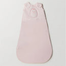 Soft pink Nested Bean Zen Sack Classic for infants, featuring a subtle bow and heart design, suitable for 3 to 6 months.