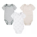 Three Nike baby bodysuits in Mica Green: one striped, one white with small logos, and one plain beige with a logo.