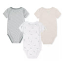 Three Nike bodysuits for babies in Mica Green, featuring a mint striped design, white with gray logo patterns, and a solid beige.