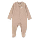 Nike baby long sleeve footed coverall in sanddrifit color, featuring a zipper and logo, designed for comfort and warmth.