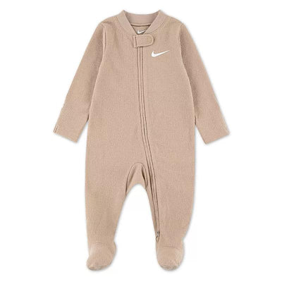 Nike baby long sleeve footed coverall in sanddrifit color, featuring a zipper and logo, designed for comfort and warmth.