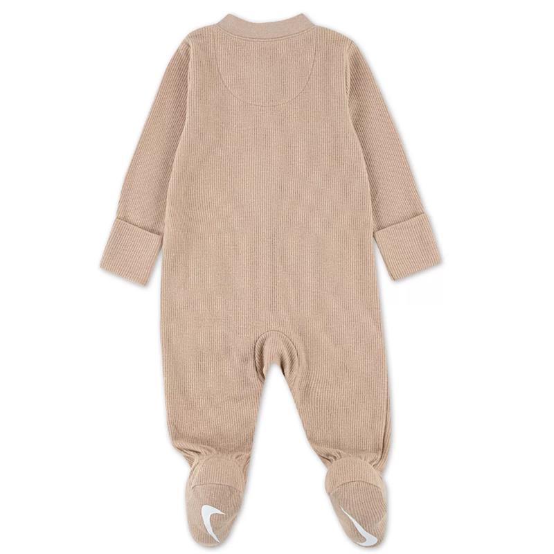 Nike baby long sleeve footed coverall in a beige ribbed fabric featuring enclosed feet and a comfortable collar.