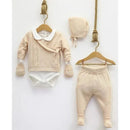 Knitted baby set in cream, featuring a wrap sweater, pants, bodysuit, and matching hat, displayed on hangers.