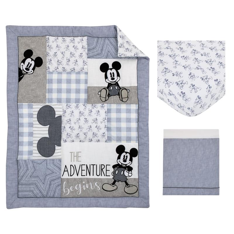 Mickey Mouse themed nursery crib bedding set featuring a quilt with patches, a fitted sheet, and a bed skirt.