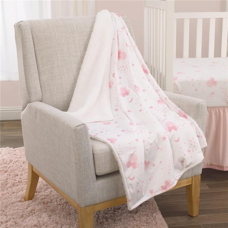 Super soft pink and white baby blanket featuring Minnie Mouse, suitable for infants, displayed on a gray armchair.